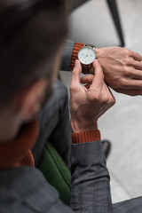 close up view of man adjusting watch on hand