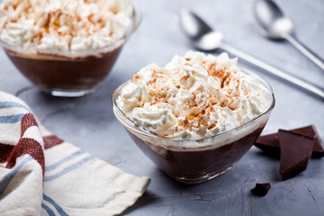 Bowls Of Chocolate Mousse With Whipped Cream And Cinnamon