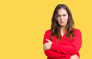 Fototapeta premium Beautiful plus size young business woman over isolated background skeptic and nervous, disapproving expression on face with crossed arms. Negative person.