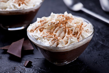 Bowls Of Dark Chocolate Mousse With Whipped Cream And Cinnamon