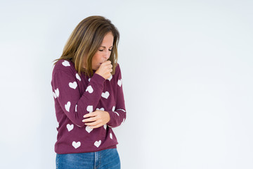 Beautiful middle age woman wearing heart sweater over isolated background feeling unwell and coughing as symptom for cold or bronchitis. Healthcare concept.