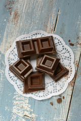 pieces of chocolate on blue wooden table