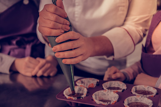 Close up of female hands with a pastry bag