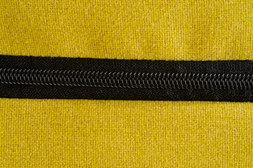 Texture of thick, strong mustard color fabric shot close-up.