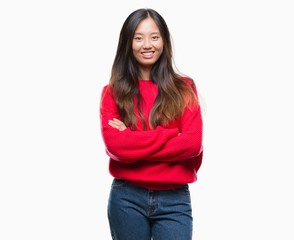 Obraz premium Young asian woman wearing winter sweater over isolated background happy face smiling with crossed arms looking at the camera. Positive person.