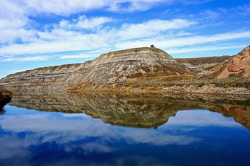Fototapeta premium Badland rock formations reflected in river