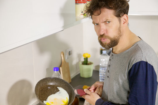 Funny Man In Kitchen Not Able To Cook An Egg