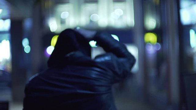 mcdonalds street city man in hood with shaved head shopping at night