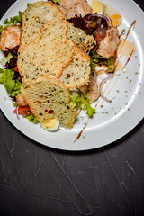 Fresh salad in plate on stone background