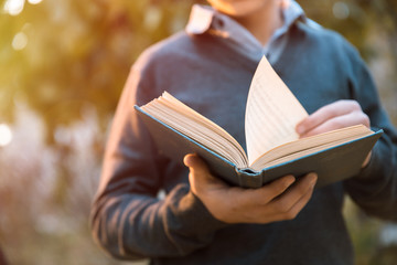 Man reading book in nature