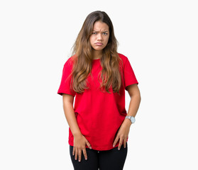 Fototapeta premium Young beautiful brunette woman wearing red t-shirt over isolated background skeptic and nervous, frowning upset because of problem. Negative person.