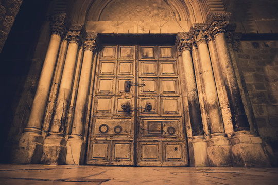 Old wooden door of entrance to the Church of the Holy Sepulchre, also called the Church of the Resurrection or Church of the Anastasis, in Old City of Jerusalem.