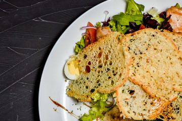 Fresh salad in plate on wooden table