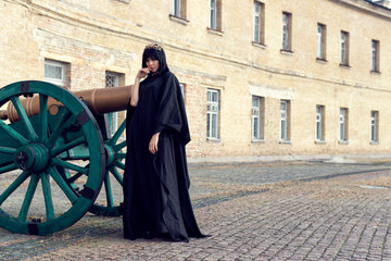 Young girl in a long black coat