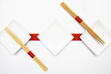Ceramic bowls  and bamboo chopsticks for sushi food .