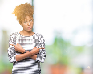 Beautiful young african american woman wearing glasses over isolated background Pointing to both sides with fingers, different direction disagree