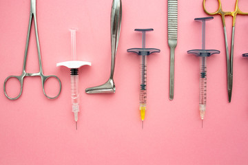 Flat lay of medical instruments on rose background. Mock up health care medical background.