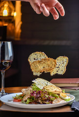 Freezer food prepare in process vegetarian salad by chef hand in home kitchen. Dark black background.