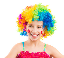 Funny little girl in clown wig with red spots on her cheeks isolated on white background