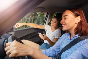 Girl pointing right way to mother during road trip