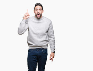 Fototapeta premium Young handsome man wearing sweatshirt over isolated background pointing finger up with successful idea. Exited and happy. Number one.
