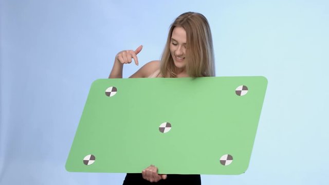 Beautiful blonde girl presenting oversized buisnesscard