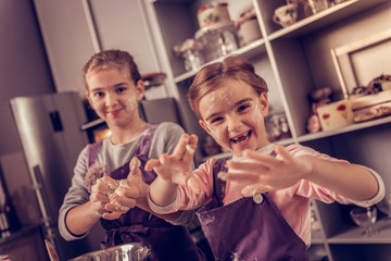 Selective focus of girls hands in flour