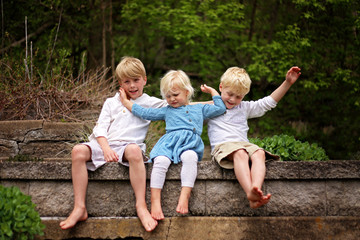 Portrait of Little Sister Child Pushing her Brothers Away - Powered by Adobe