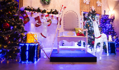 chair for Santa Claus and boxes with gifts in a cozy living room