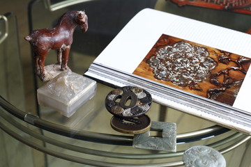 Still life of various antiques on a glass table