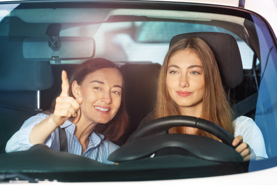 Woman pointing finger on something sitting in car