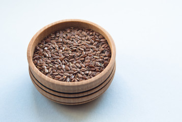 flax seeds in bowl on white background