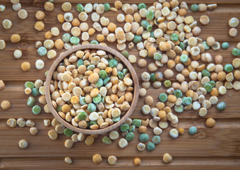 multicolor peas on wooden background