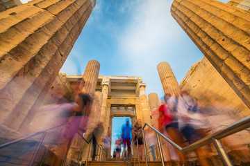 People pass through the Propylaea monumental entrance to the Parthenon temple in Athens, Greece