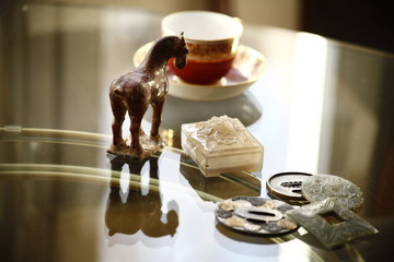 Still life of various antiques on a glass table