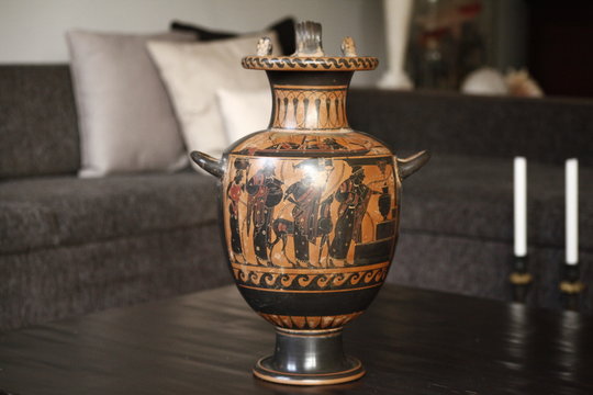 Antique black vase on a table in a living room