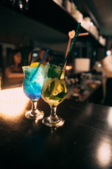 Cocktails at the bar with a blurred background.