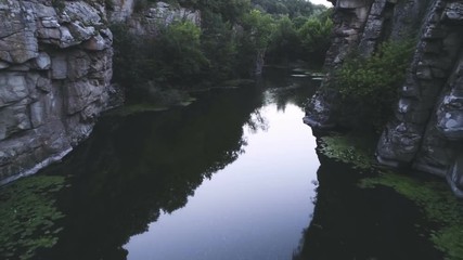 Mountain pond surrounded with high rocky walls in the Carpathians in summer