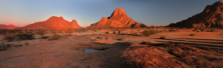 Panoramic, desert landscape of famous rounded red, granite rocks of Spitzkoppe area in early...