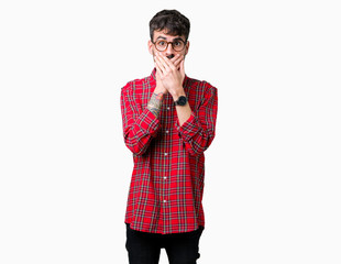 Young handsome man wearing glasses over isolated background shocked covering mouth with hands for mistake. Secret concept.