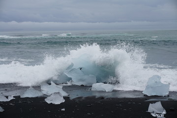 Beautiful beach near Jokulsarlon with black lava sand and ice cubes on Iceland