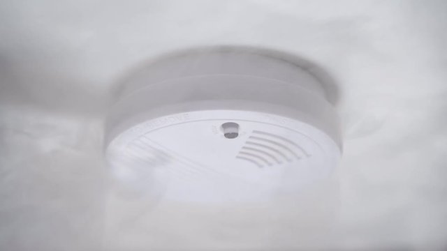 Smoke detector or fire alarm system on ceiling.