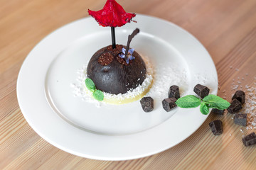 Delicious sugar dessert with chocolate and mint on plate. Photo for menu,  baked food concept