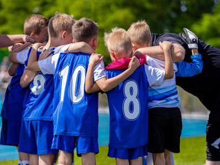 Kids Sports Team. Group of Soccer Team Players Standing Together With Coach. Coach Giving Young Sports Team Instructions. Sports Club For Kids. Coaching Youth Football