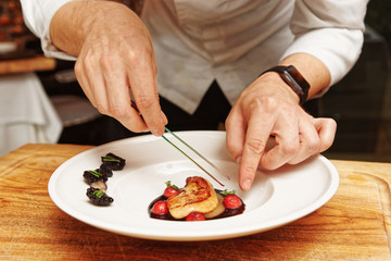 Chef is serving foie gras, toned