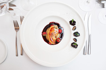 Foie gras dish on restaurant table, toned
