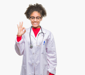 Young afro american doctor woman over isolated background smiling positive doing ok sign with hand and fingers. Successful expression.