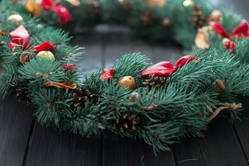 Natural Christmas wreath on black wooden background