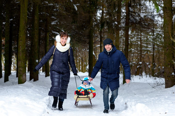 family walk in the winter forest dad mom and child