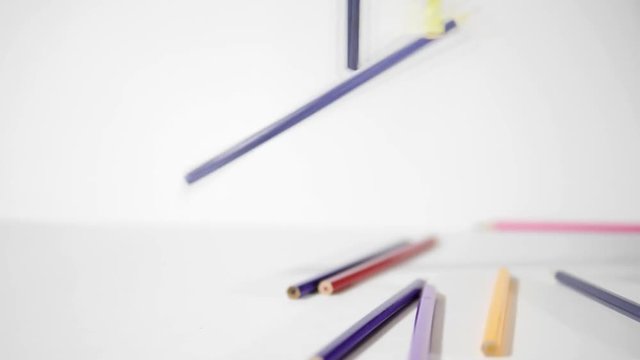 Pencil on a white background. Colouring pencils falling on white background in slow motion